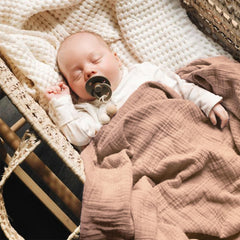 Three bold Konssy muslin swaddle blankets in colors for unisex outfits