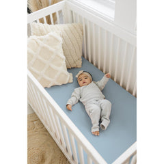 Close-up of soft, 100% cotton muslin fabric gentle on newborn skin.