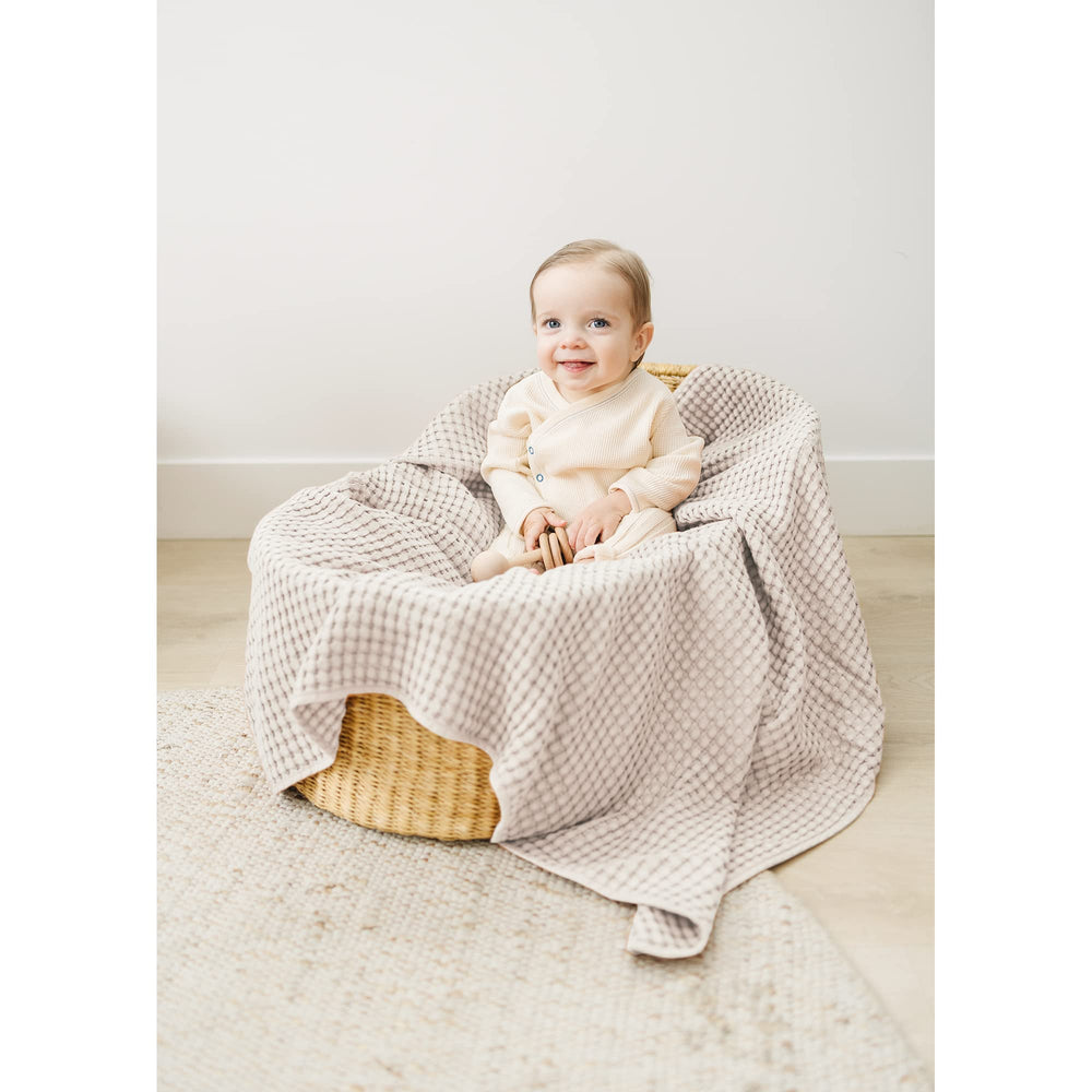 Konssy Waffle Baby Blanket in crib setup as a comfy throw.