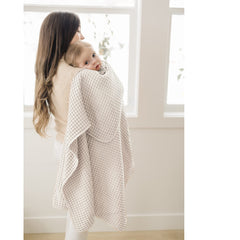 Konssy Waffle Baby Blanket flatlay in oat color, versatile accessory.