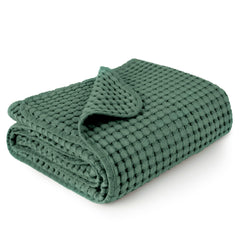 Konssy waffle baby blanket folded, a cozy nursery essential.
