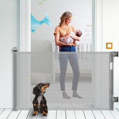 KYXAIN retractable baby gate in grey fits doorways up to 71 inches wide for flexible safety.