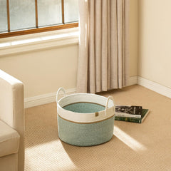 La Jolie Muse 32L basket in ivy green ready for blankets and toys.