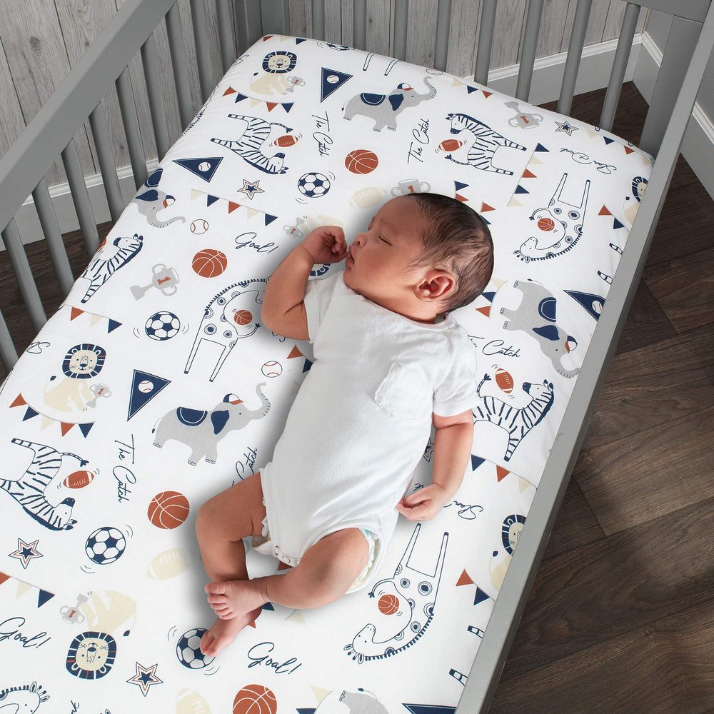Lambs & Ivy closeup of custom animals playing sports design on crib sheet