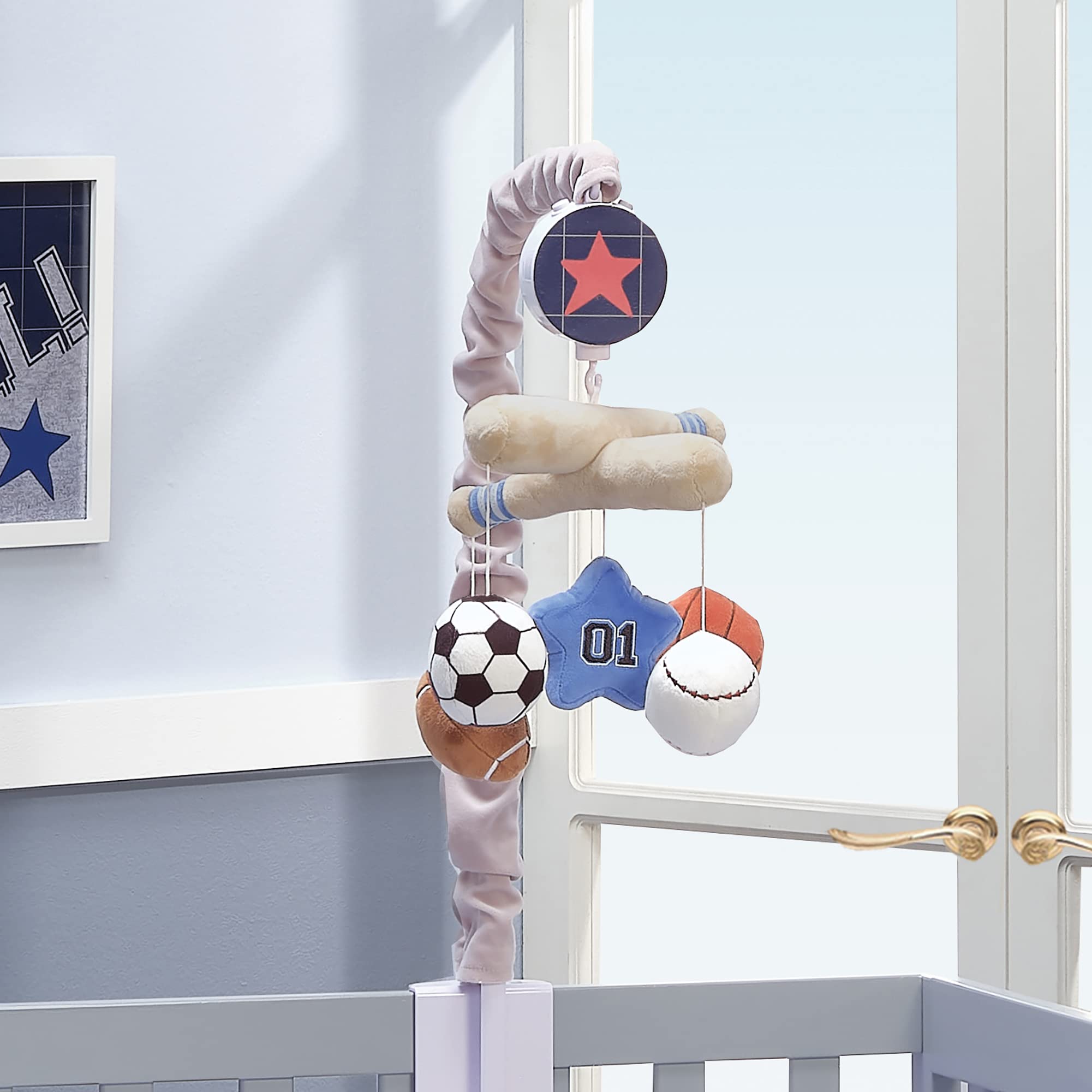 Lambs & Ivy blue embroidered star adds soft color near the crib.