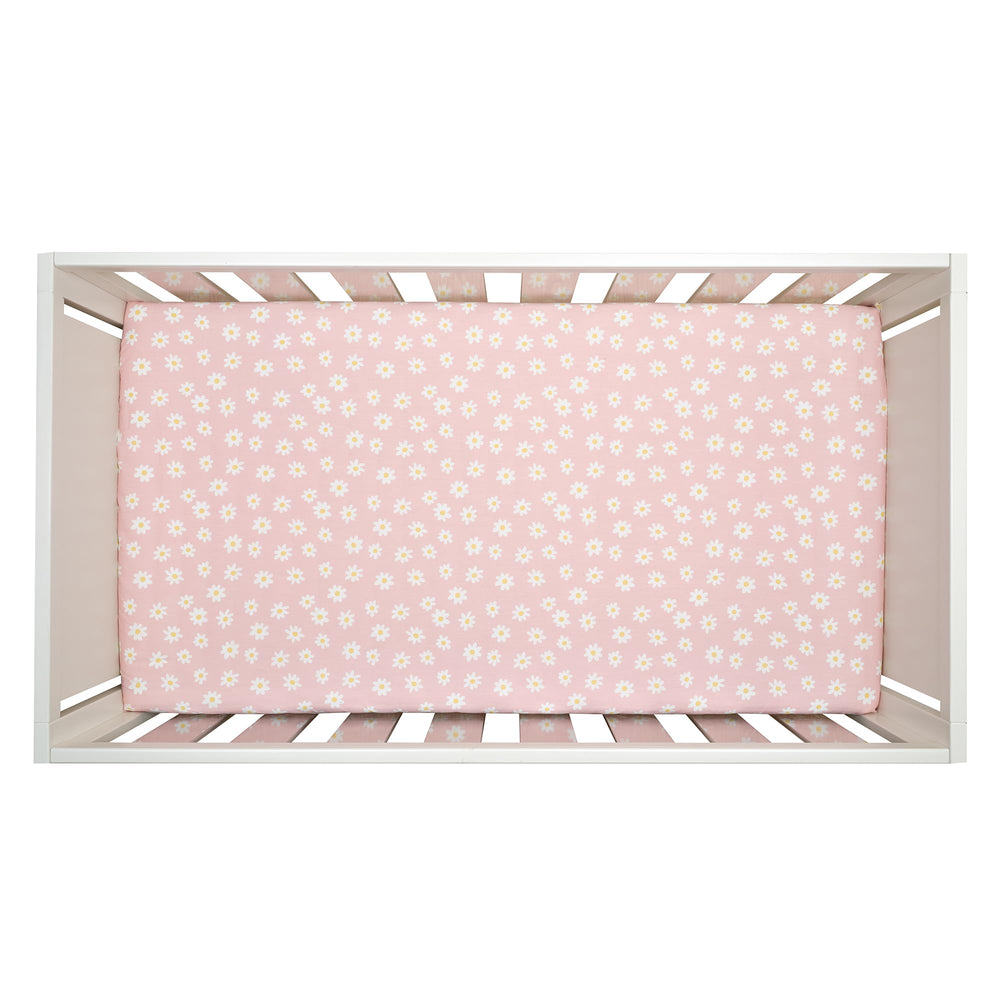 Lambs & Ivy Daisy Dreams elastic-fit sheet stays snug on crib mattresses.