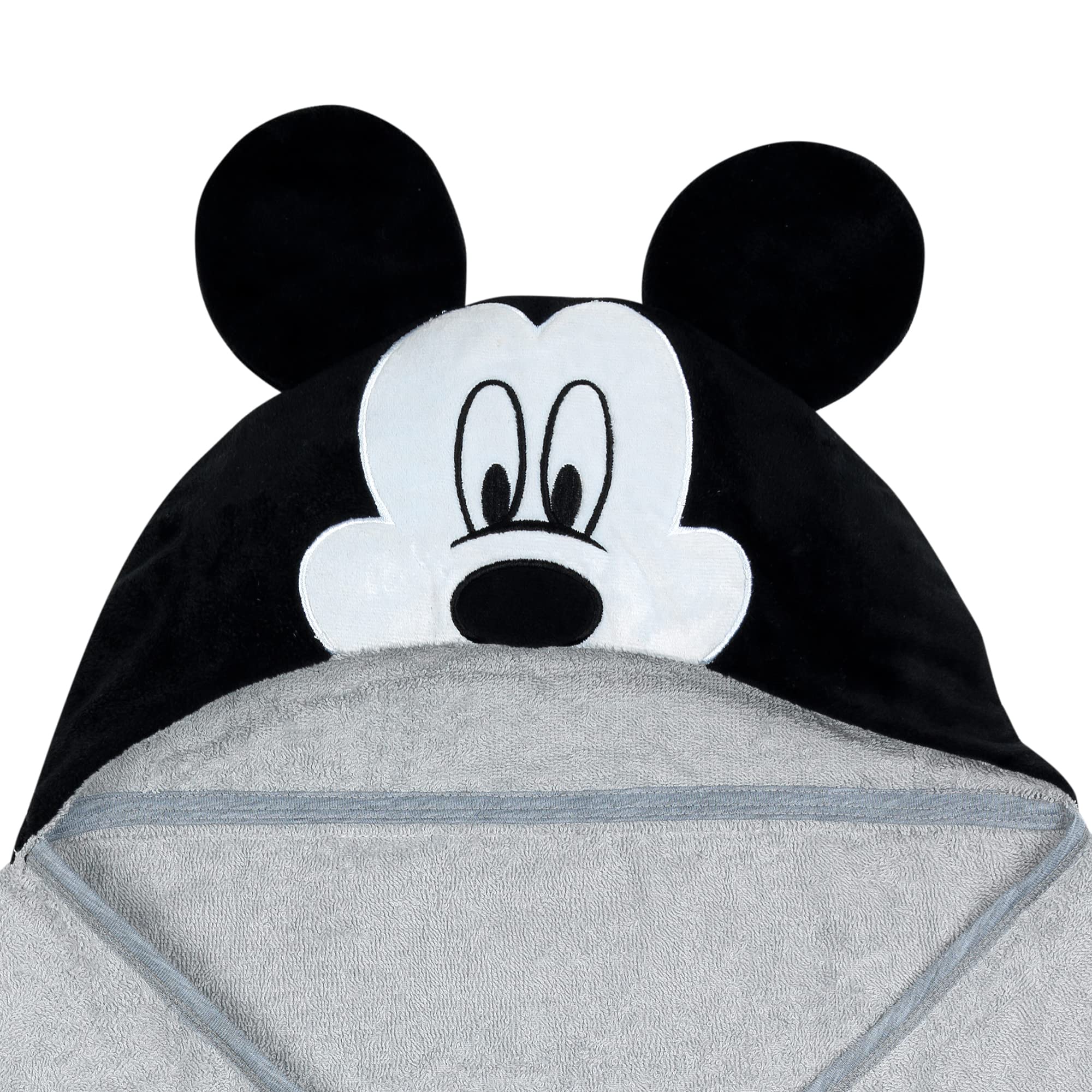 Lambs & Ivy Mickey towel on baby demonstrates absorbent cotton terrycloth after bath.