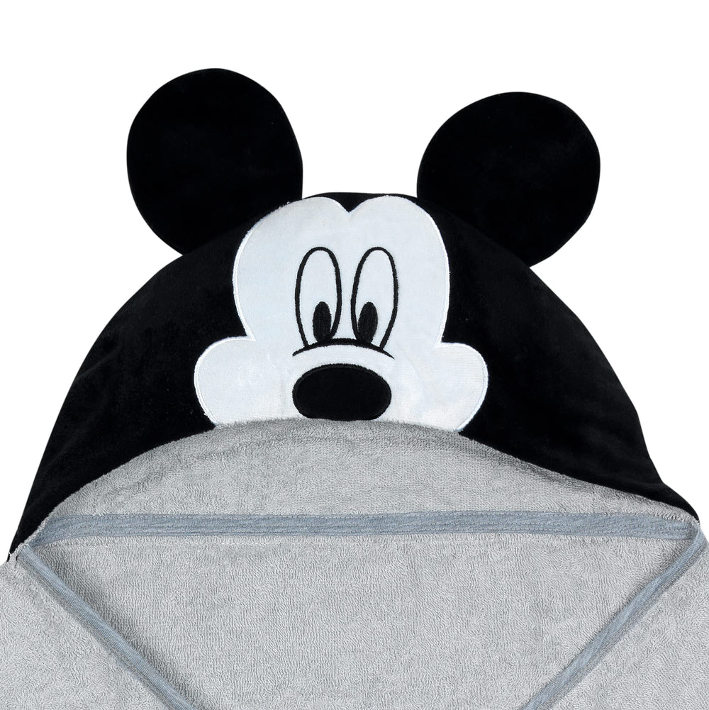 Lambs & Ivy Mickey towel on baby demonstrates absorbent cotton terrycloth after bath.