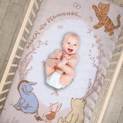 Lambs & Ivy Pooh Bear & Pals crib sheet with elastic edge for secure fit.