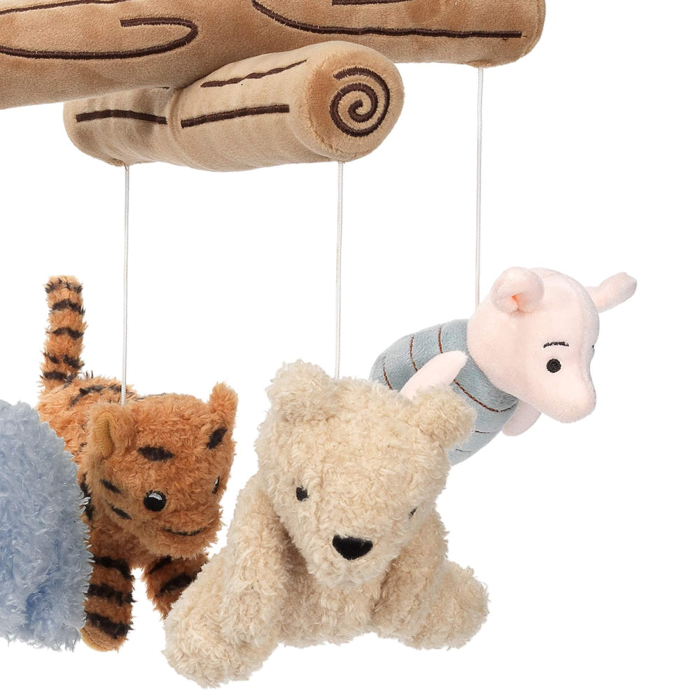 Pooh plush characters on Lambs & Ivy mobile rotating to hold baby’s attention