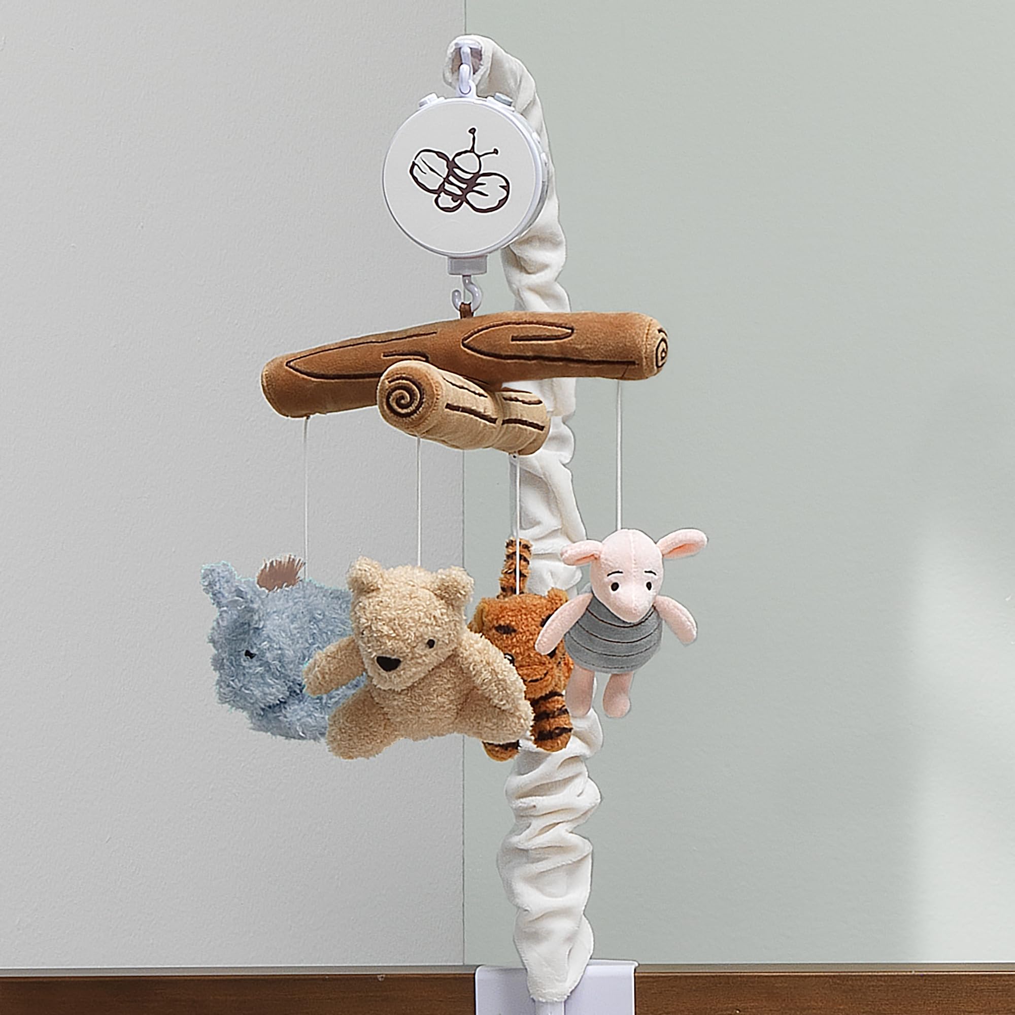 Soft visual and auditory stimulation from Pooh characters on Lambs & Ivy mobile