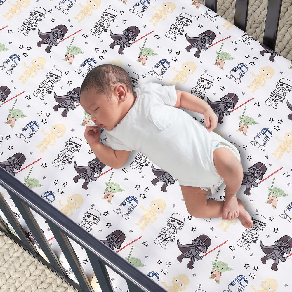 Lambs & Ivy Star Wars sheet featuring R2-D2 and stormtroopers for playful toddler room