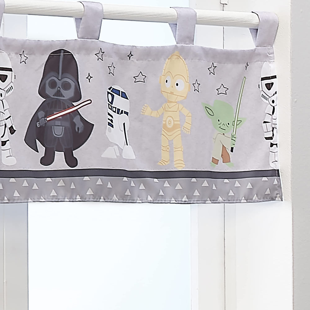 Lambs & Ivy Star Wars valance featuring R2-D2 brightens the space.