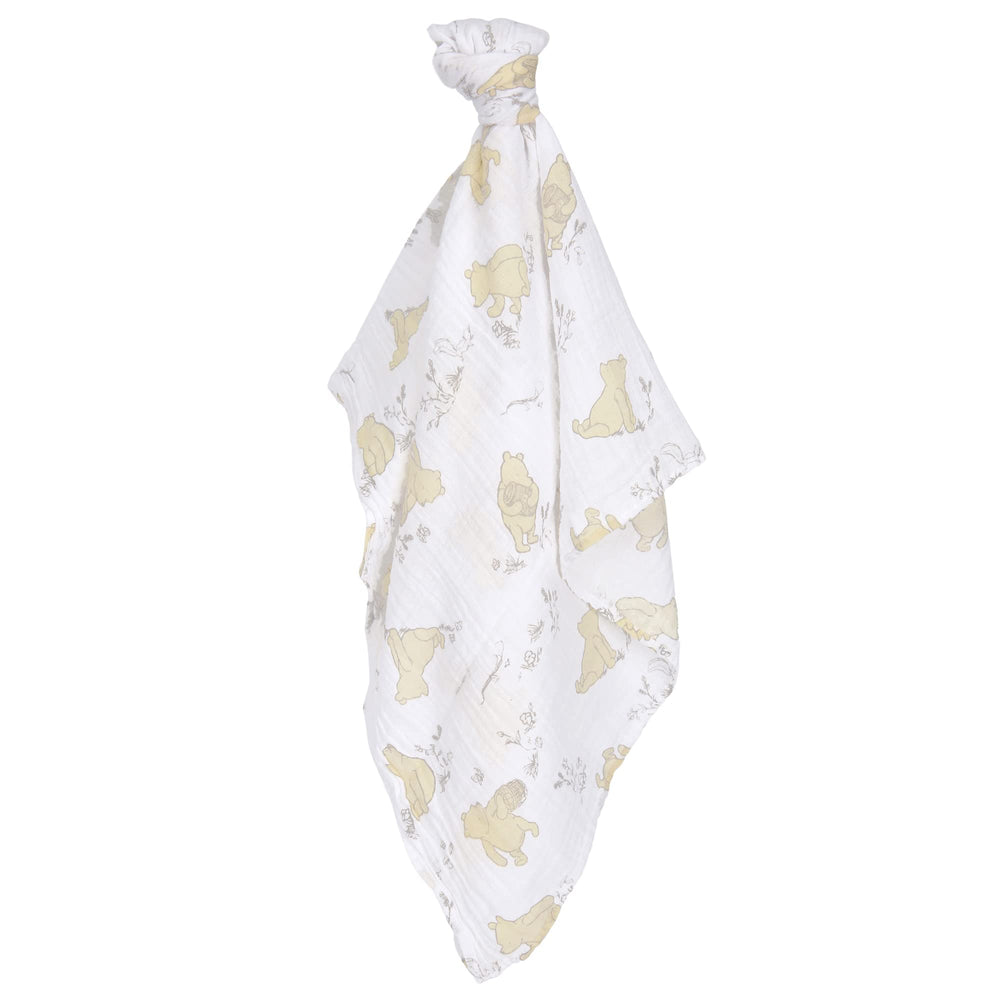Lambs and Ivy Winnie the Pooh swaddle set in crib for soothing moments.