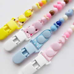 Langmeil white pacifier clip closeup showing durable fabric-friendly grip.