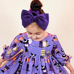 Lanmerry skull-pattern bow adds playful style to baby's Halloween outfit.