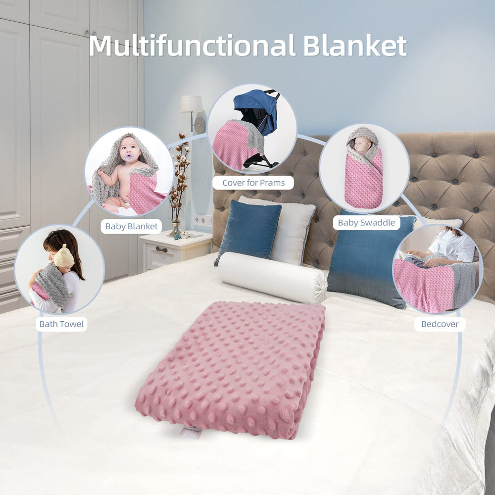 LAT LEE AND TOWN Minky Dot blanket in baby's arms for cozy all-season warmth.
