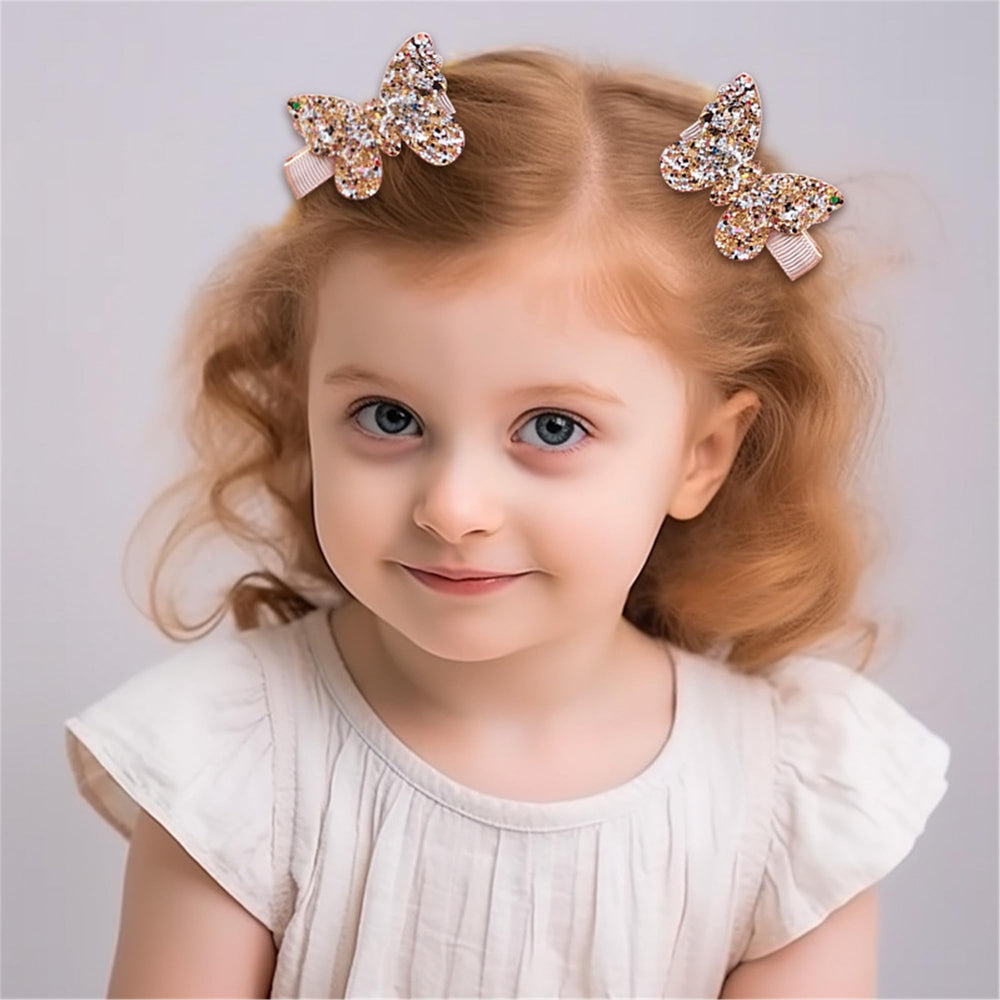 LDDCX glitter gold bows hair clip on toddler hair for cute everyday outfits.