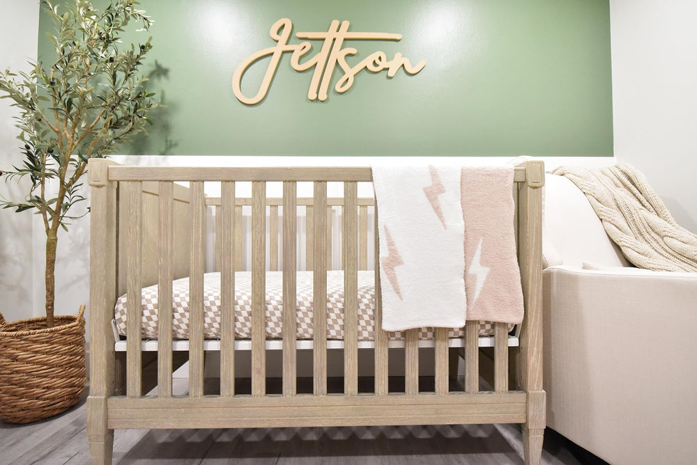 Leaps + Legends Lightning Bolt blanket shown as a soft playmat backdrop.