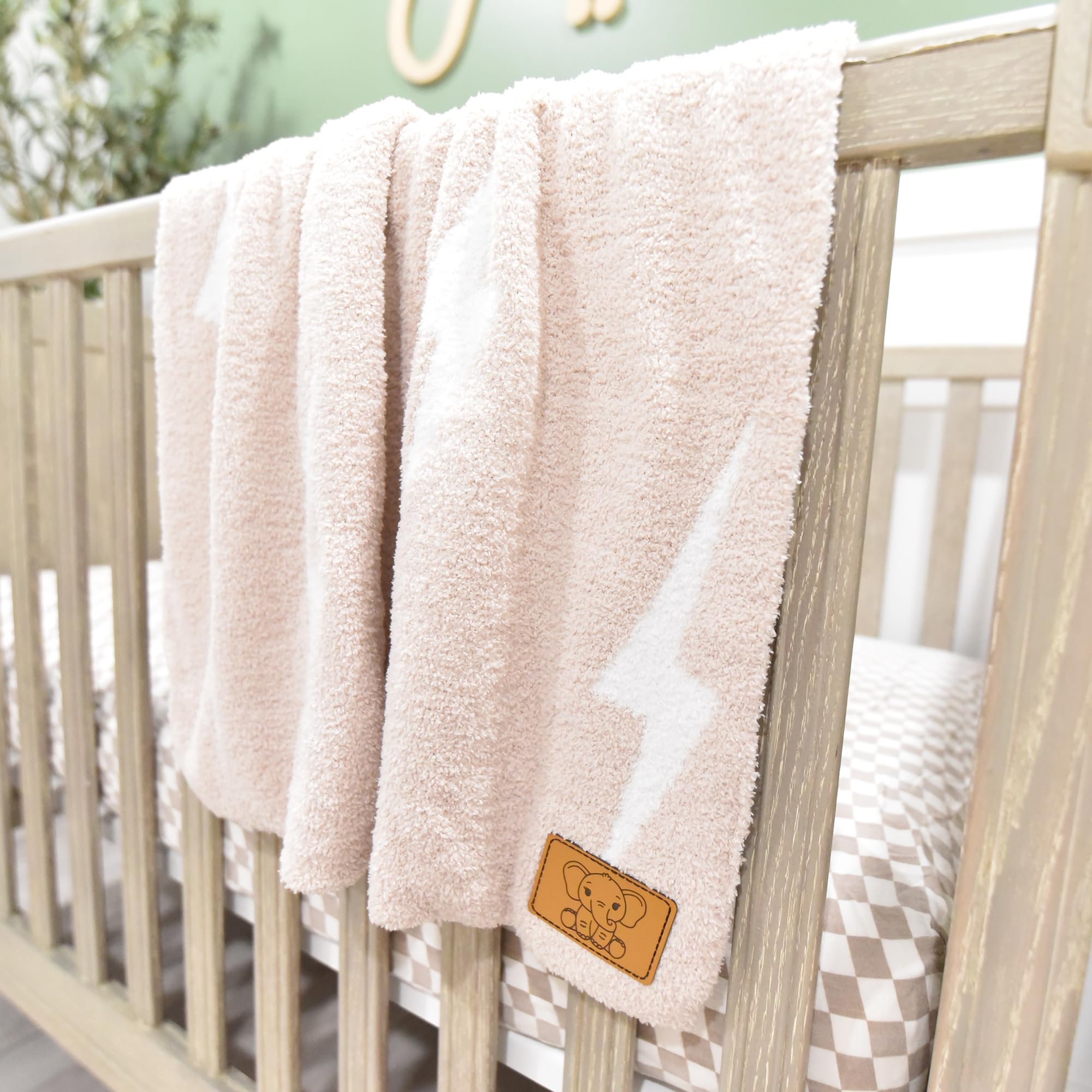 Tan/White Leaps + Legends Lightning Bolt blanket with gender-neutral appeal.