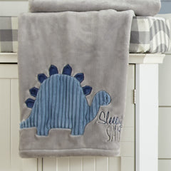 Kipton blanket detail shows embroidered dinosaur highlights, adding tactile interest during cuddle time.