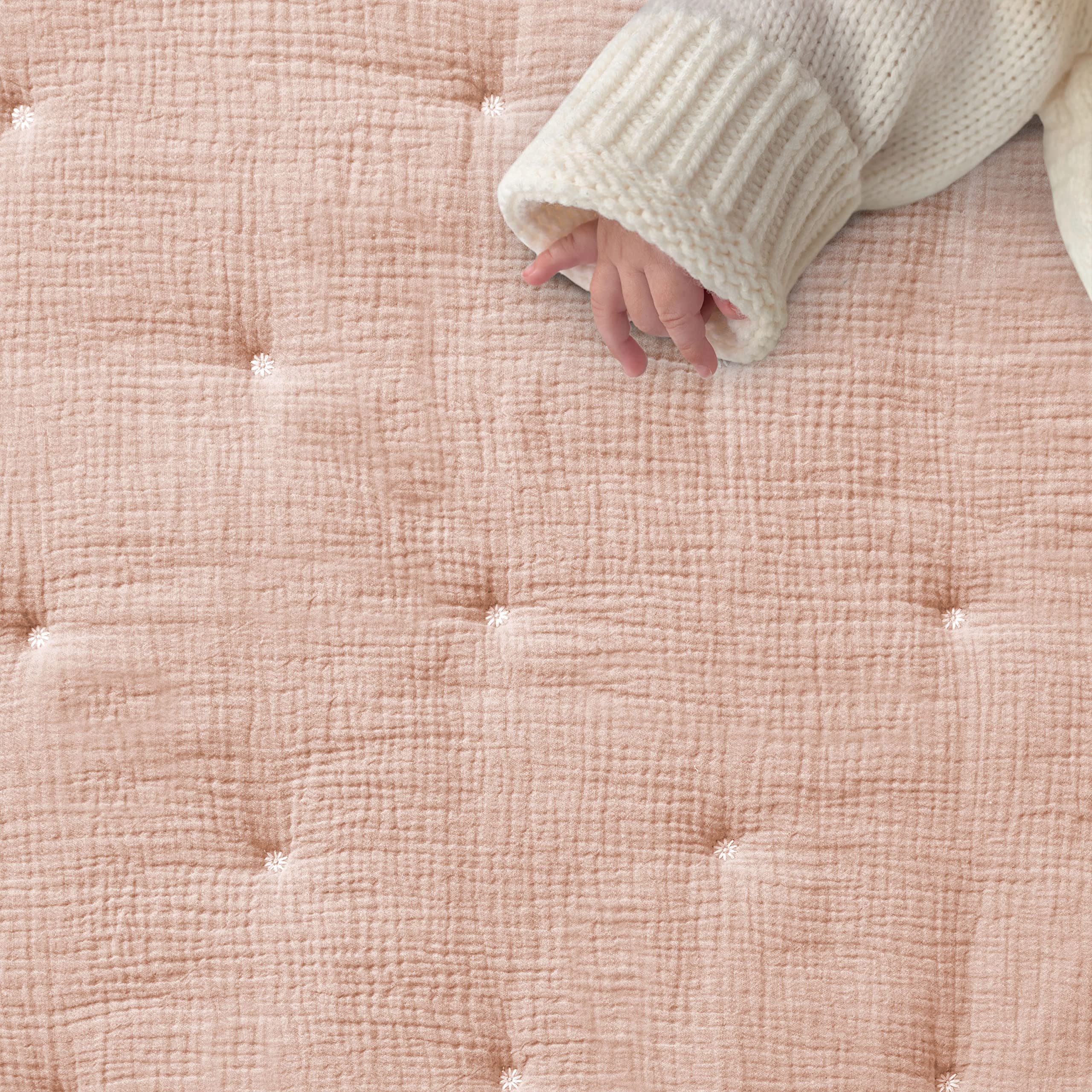 Levtex Baby pink textured muslin fitted sheet providing snug mattress fit.