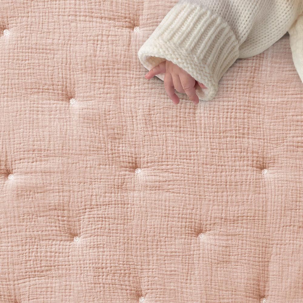 Levtex Baby pink textured muslin fitted sheet providing snug mattress fit.