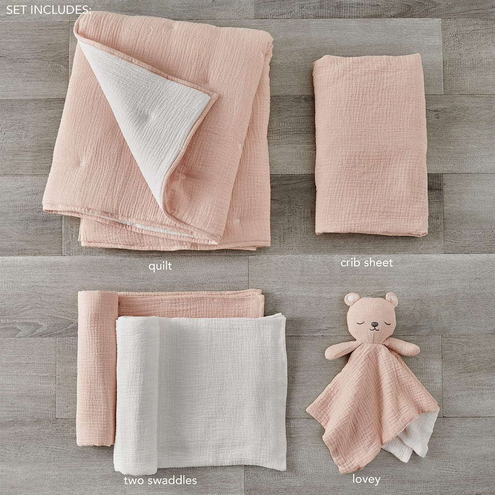 Levtex Baby quilt highlighting pink textured muslin with white stitching for cozy naps.