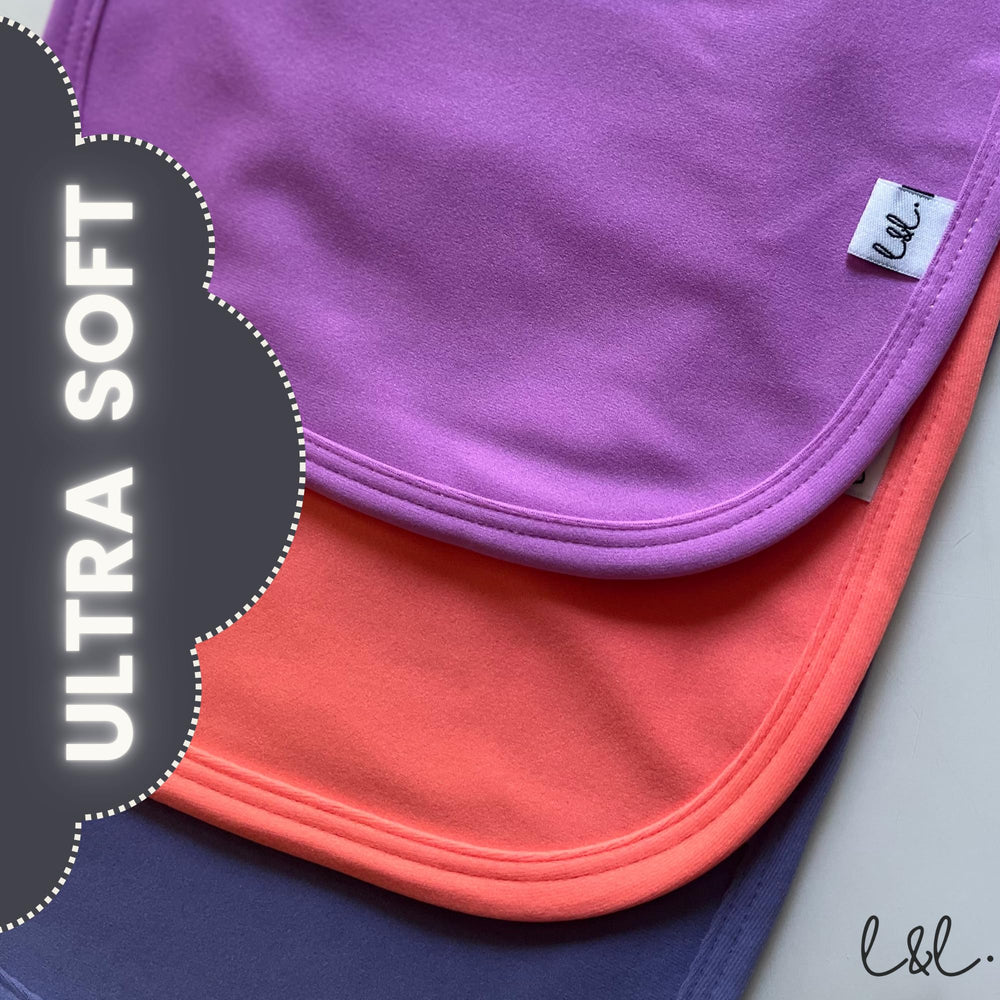 Leya & Lior StayDri bib three-pack in tropical colors.