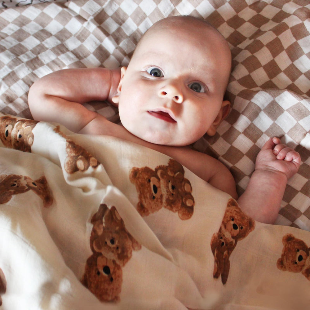 LifeTree muslin swaddle with checkered pattern provides soft, breathable wrap for soothing baby.