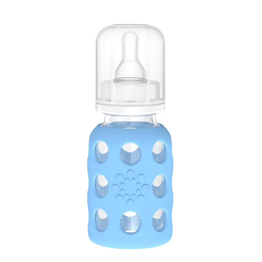 Lifefactory 4-Oz sky blue glass baby bottle with silicone sleeve offering secure grip.