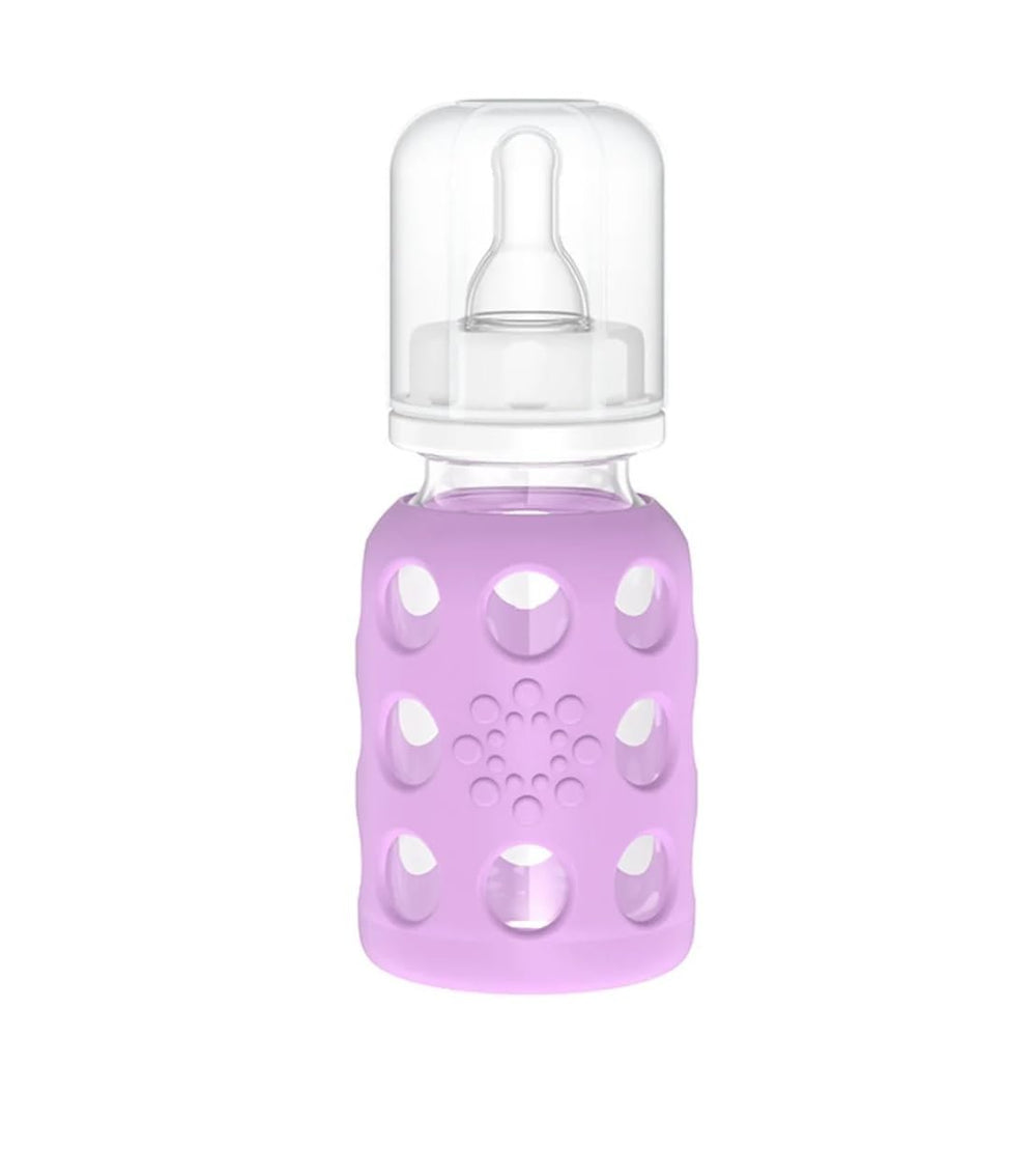 Lifefactory cap, ring, and stopper securing the bottle.