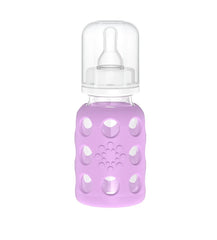Lifefactory cap, ring, and stopper securing the bottle.