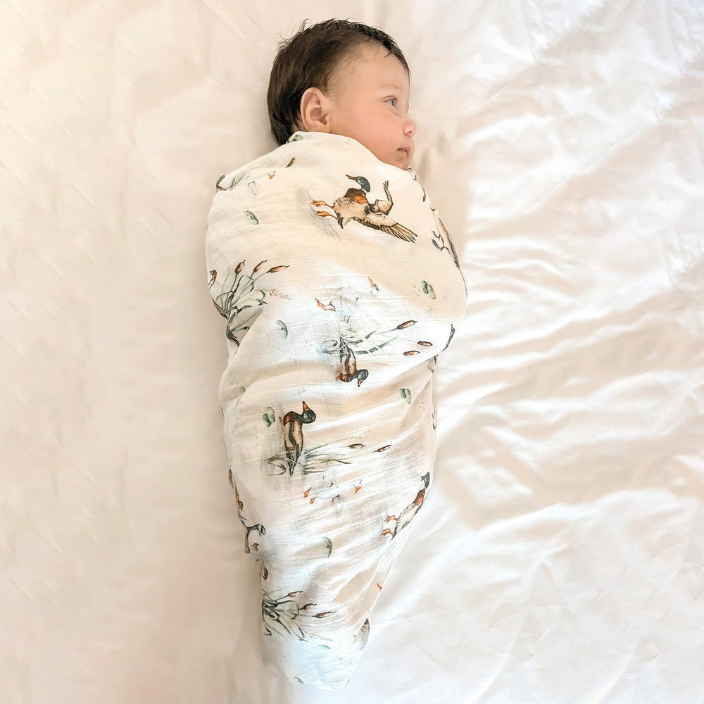 LifeTree olive-green swaddle blanket provides gentle coverage for naps and outings.
