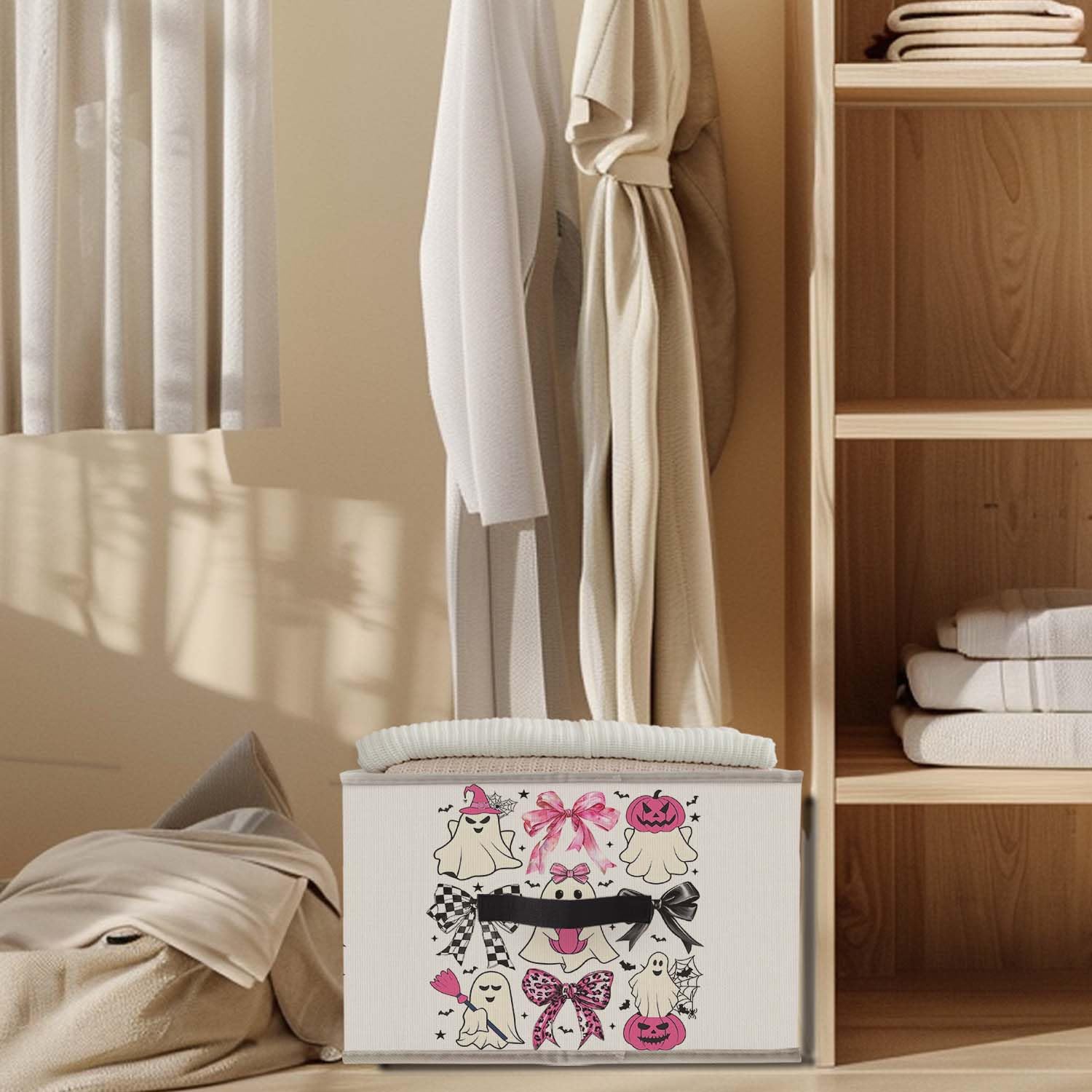 Pink ghost print design on the storage bin adds whimsical charm on a shelf