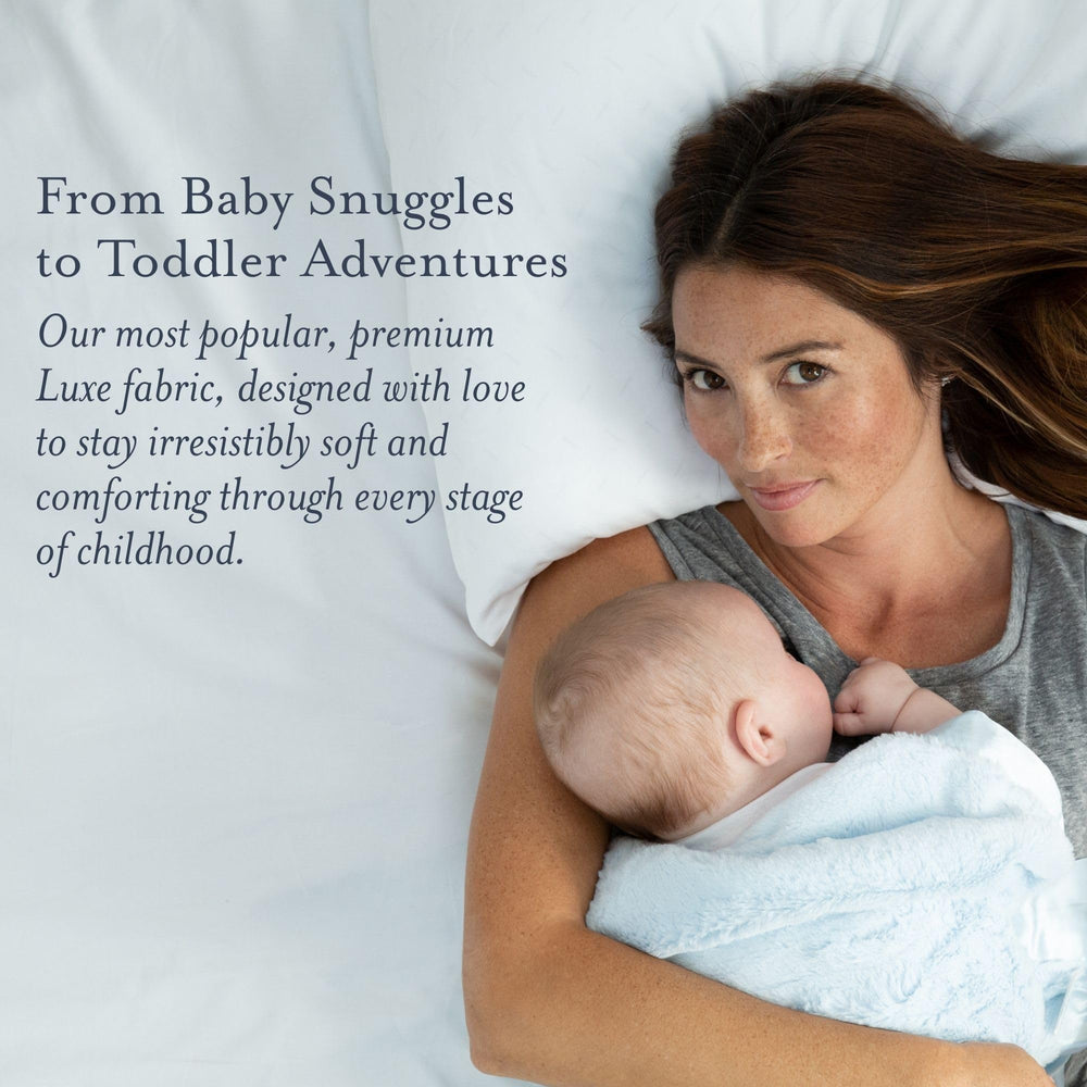 Little Giraffe Luxe blanket in stroller scene demonstrates lightweight comfort on the go.