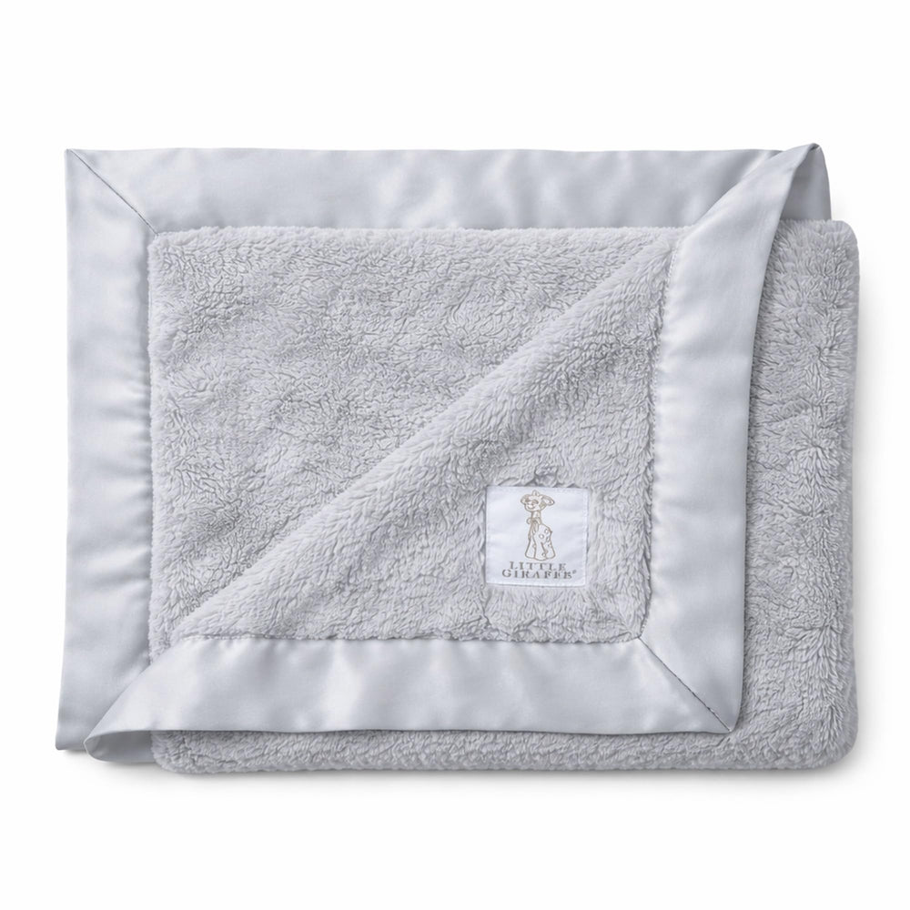 Little Giraffe Luxe Soft Blanket with satin trim for gentle newborn warmth.