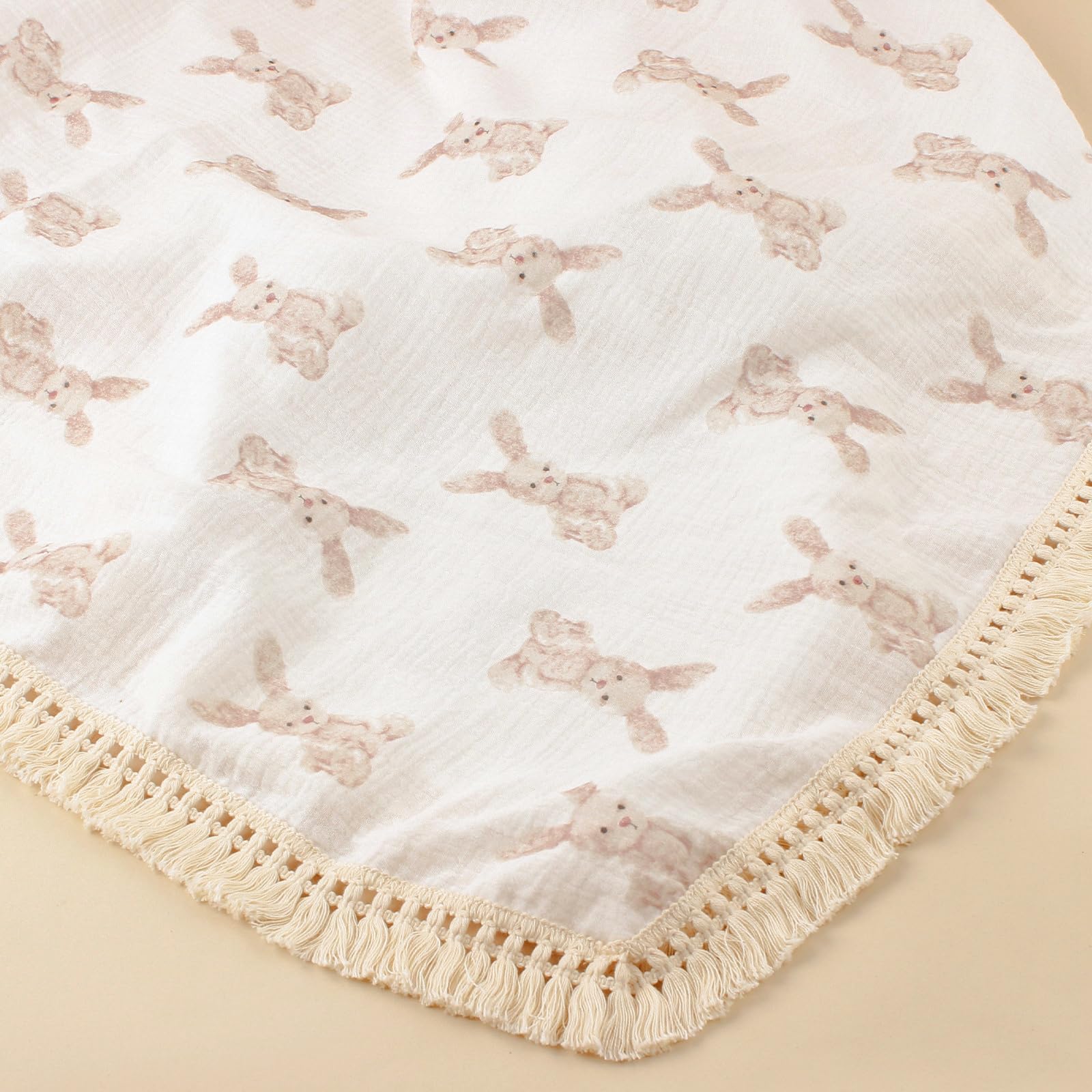 Little Jump boho fringe trim on muslin blanket for chic nursery decor.