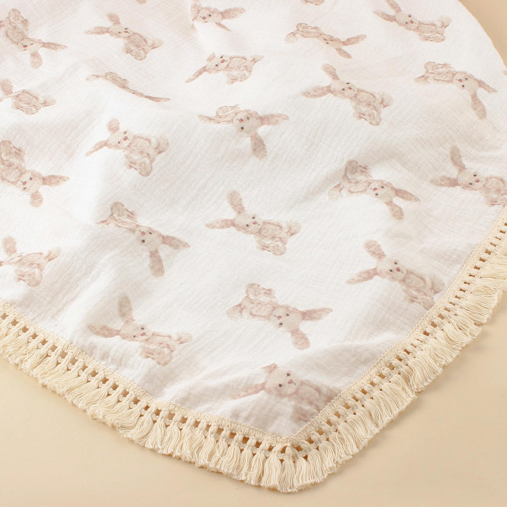 Little Jump boho fringe trim on muslin blanket for chic nursery decor.