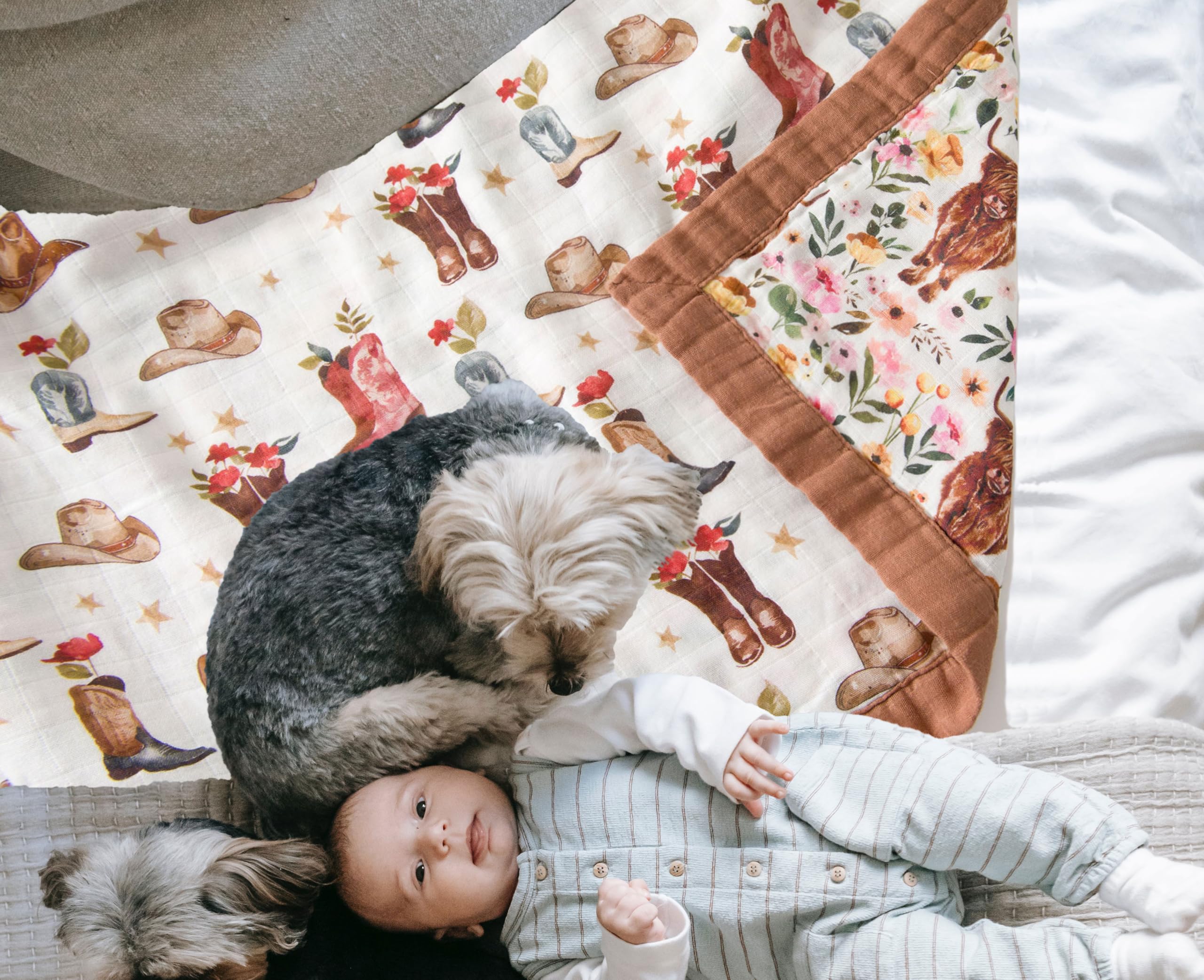 Little Jump cowgirl floral Highlandcow muslin blanket draped over crib for cozy days.