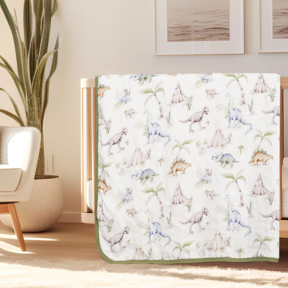 Little Jump Dinosaur Muslin Blanket large 47x47 inches shown as roomy toddler bed cover.