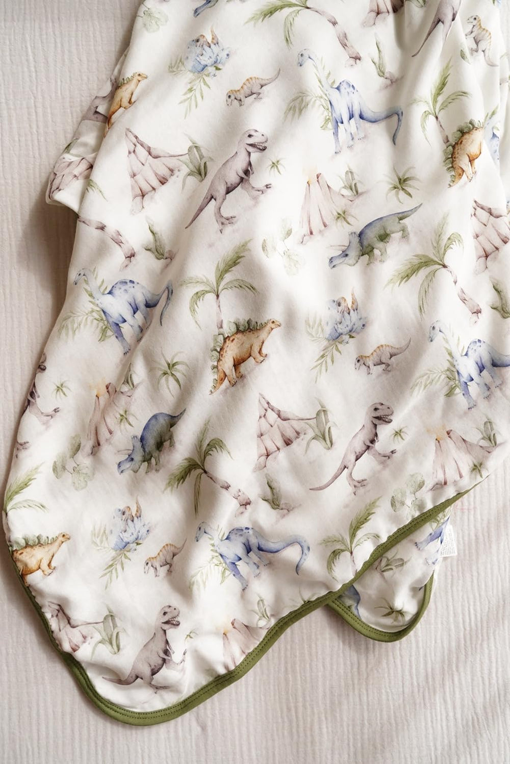 Little Jump Dinosaur Muslin Blanket neutral boho color suits nursery decor.