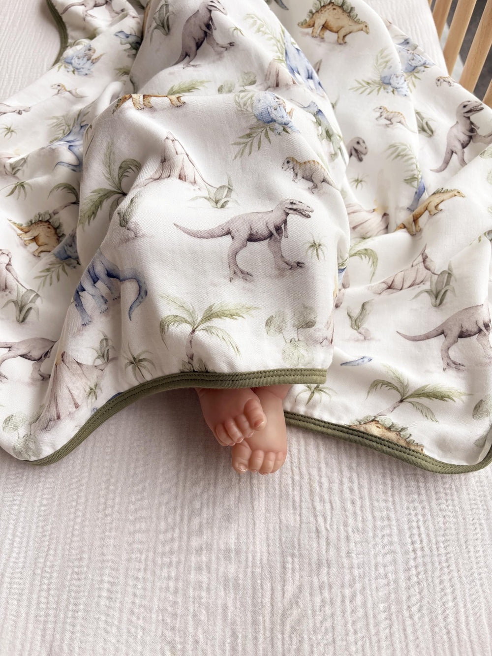 Little Jump Dinosaur Muslin Blanket stroller-ride with light coverage on outings.