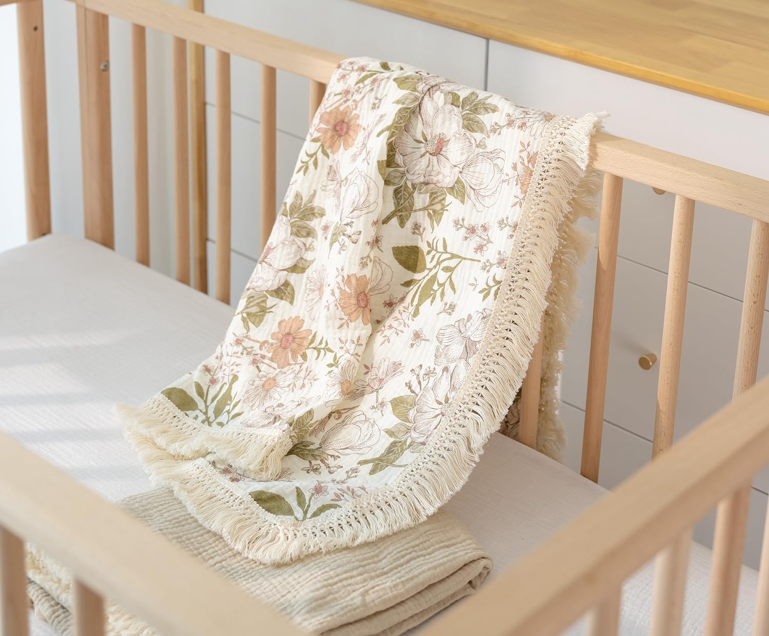 Little Jump boho nursery decor blanket complements crib setups.