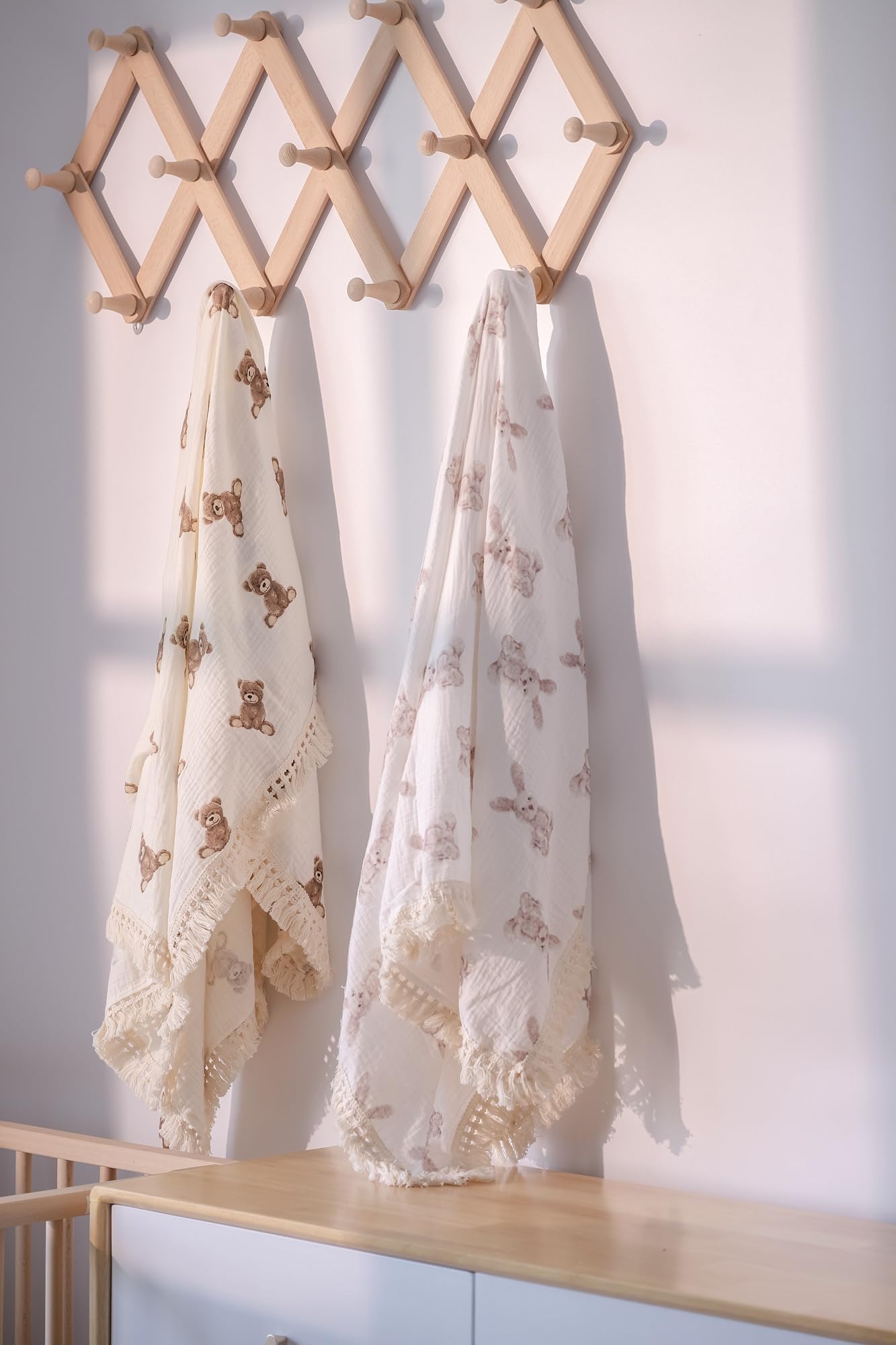 Little Jump nursery decor muslin blanket in neutral tones for stylish photos.