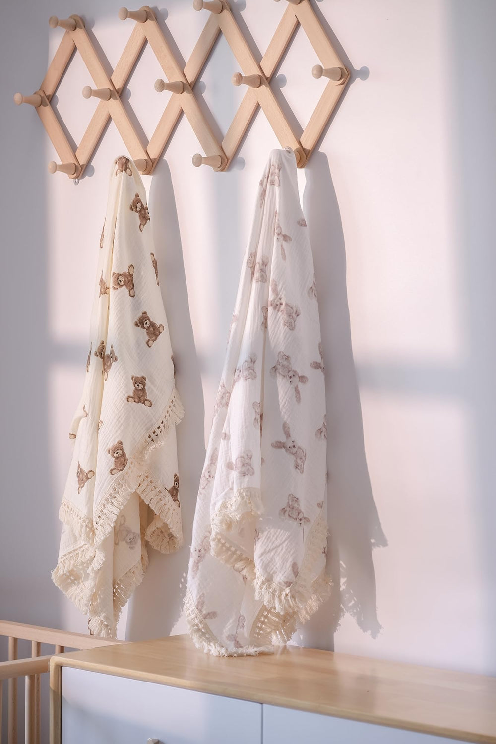 Little Jump nursery decor muslin blanket in neutral tones for stylish photos.