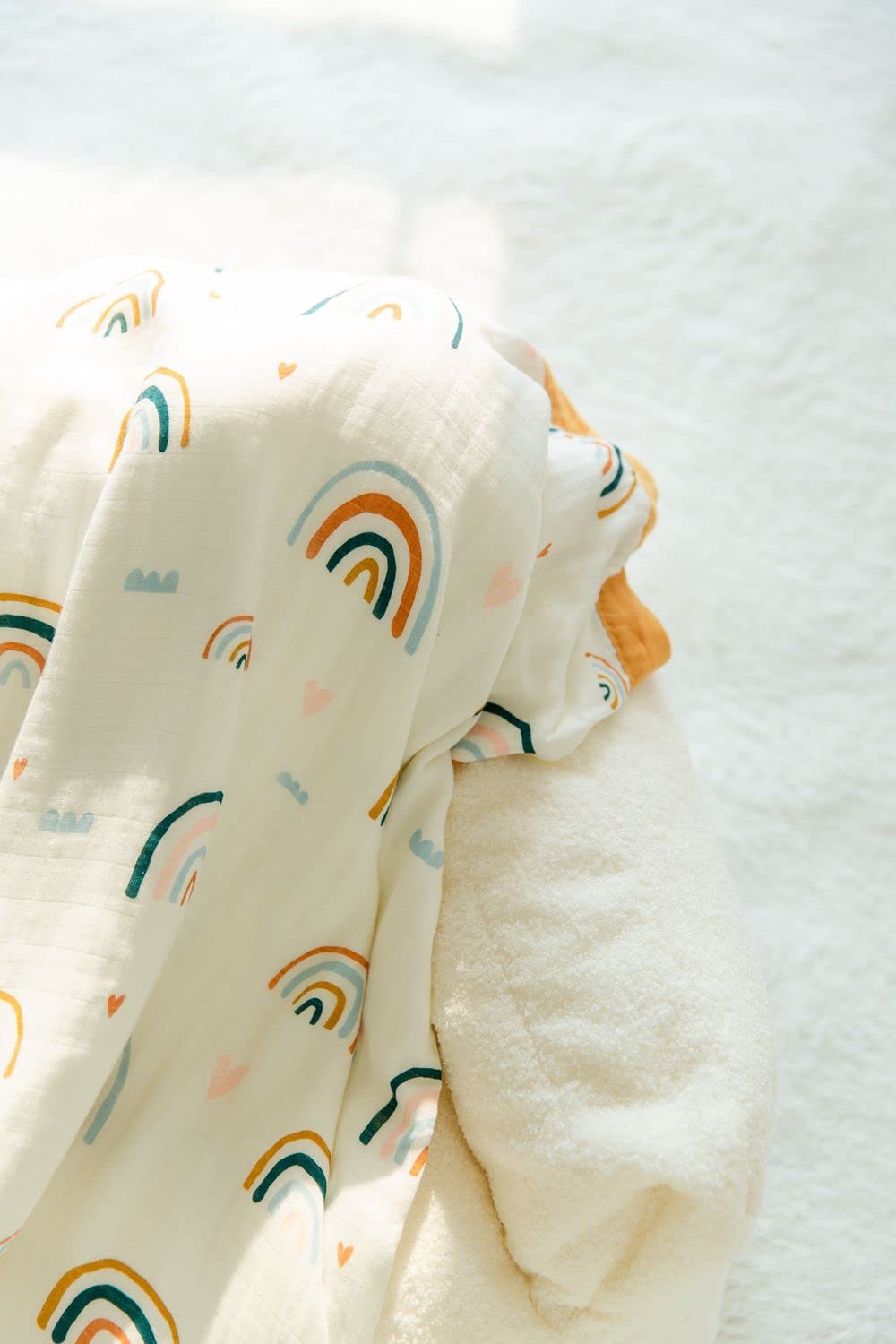 Product packaging showing care label for Little Jump Rainbow Muslin Quilt.