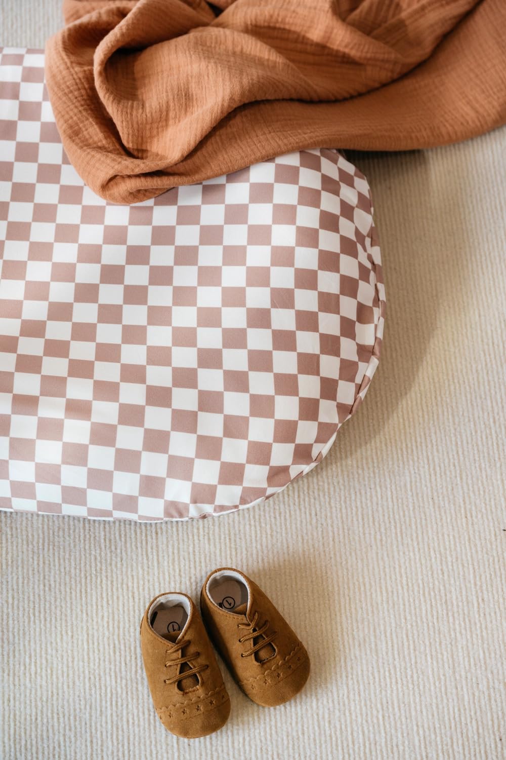 Little Jump snuggle-me-compatible cover in coffee checkered for cozy newborn lounging.