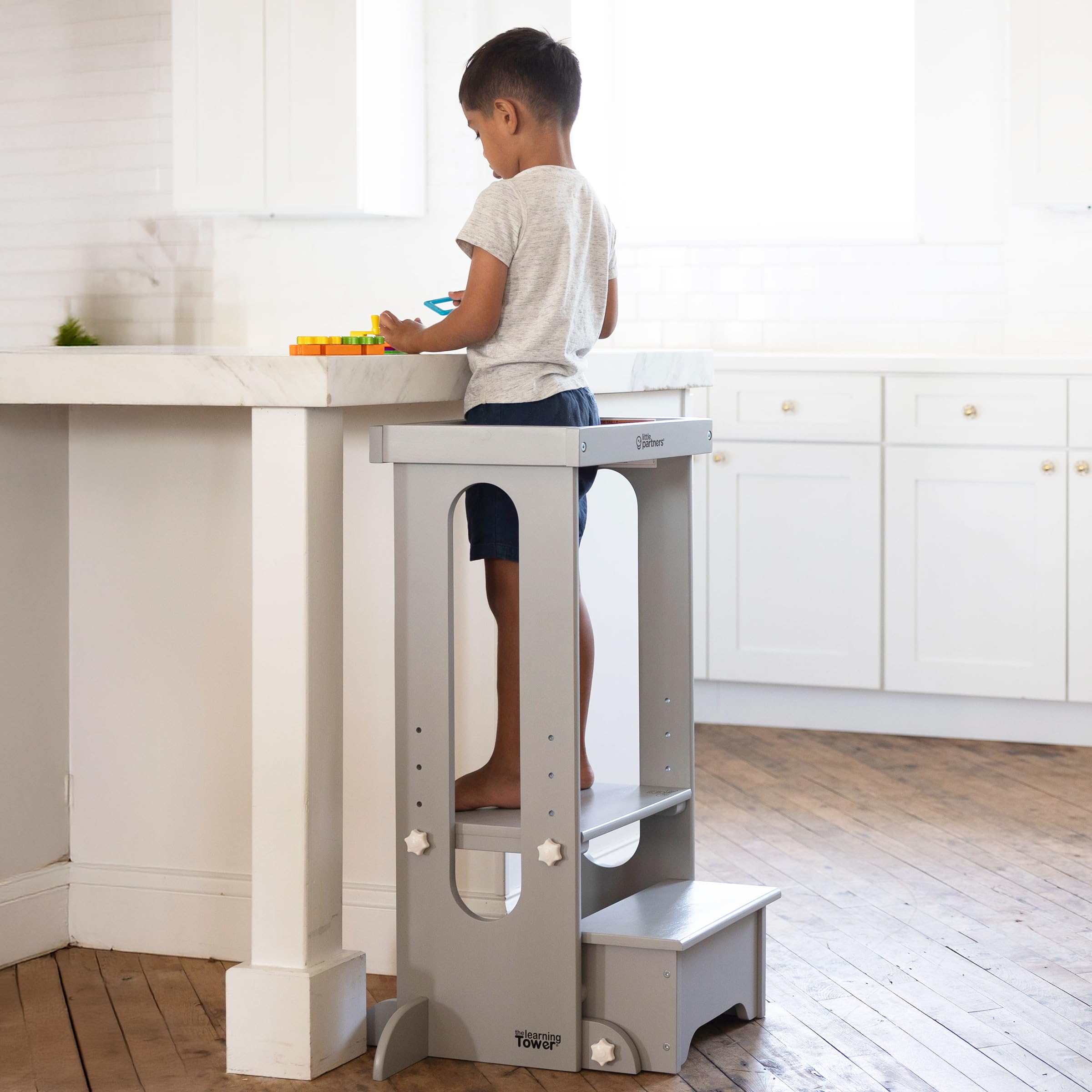 Little Partners Foldable Toddler Tower folded for storage, space saving design after activity