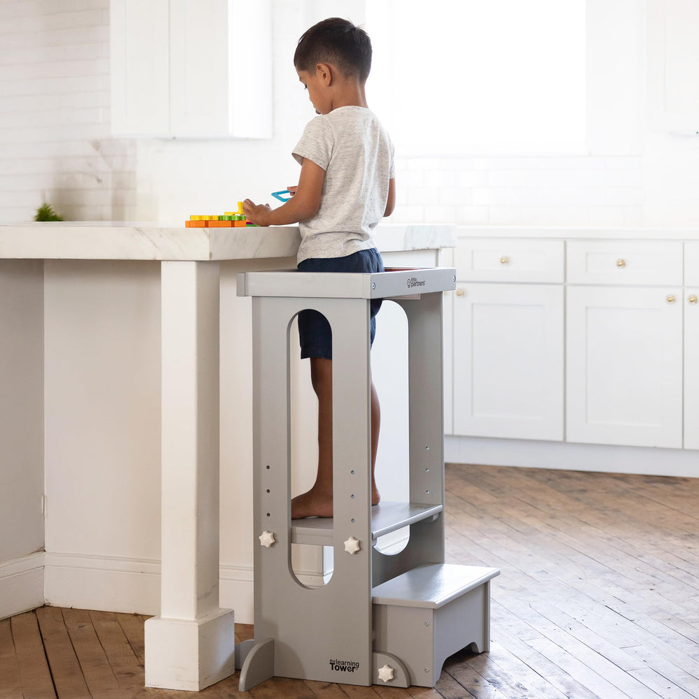 Little Partners Foldable Toddler Tower folded for storage, space saving design after activity